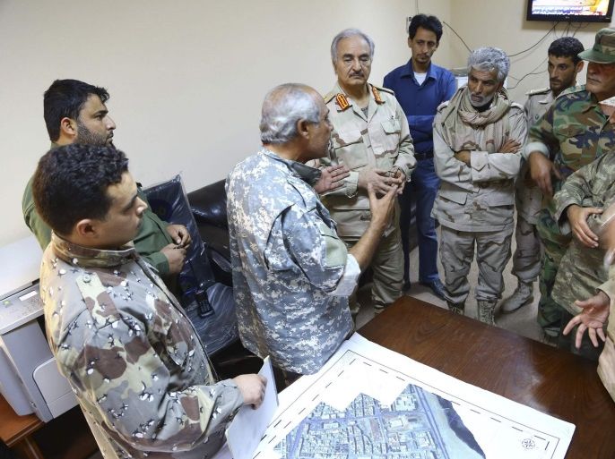 General Khalifa Haftar (4th L) talk about military operations with Libyan army commanders in Benghazi December 3, 2014, where clashes between pro and anti-government forces have taken place. Libya has two governments and parliaments vying for power since a group called Libya Dawn seized the capital Tripoli in August after a month-long battle with a rival group and set up its own cabinet. Internationally recognised Prime Minister Abdullah al-Thinni's government has allied itself with forces of Haftar who had declared war on Islamists in May. Picture taken December 3. REUTERS/Stringer (LIBYA - Tags: CIVIL UNREST POLITICS MILITARY)