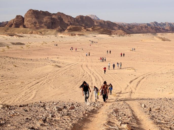 Hikers walk through the Wadi Hudra area near Ras Ghazala, South Sinai, Egypt, November 21, 2015. Bedouins in the "Sinai is Safe" group guided more than 100 hikers over a 25 km (15 mile) trek over the trails of the White Canyon and the Closed Canyon. The NGO aims to challenge mainstream perceptions of the area by encouraging Nile Valley residents to explore the untamed wilderness with the Bedouin tribes. Picture taken November 21, 2015. REUTERS/Asmaa Waguih