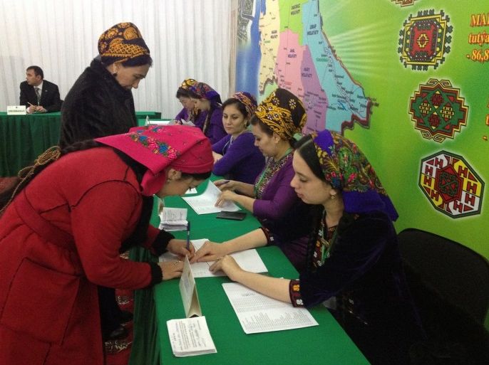 A woman signs to collect her ballot during a presidential election at a polling station in Ashgabat, Turkmenistan, February 12, 2017. REUTERS/Marat Gurt