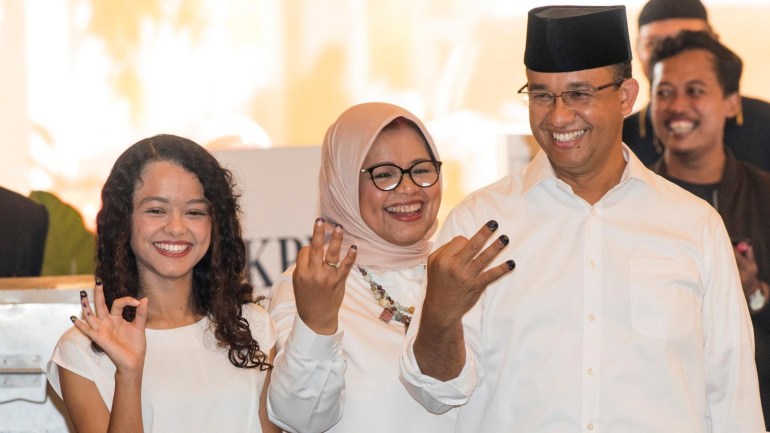 Anies Baswedan (R), a candidate in the running to lead the Indonesian capital Jakarta, his wife Fery Farhati Ganis and his daughter Mutiara Annisa Baswedan, show their fingers during an election for Jakarta's governor in Jakarta, Indonesia, February 15, 2017 in this photo taken by Antara Foto. Antara Foto/M Agung Rajasa/ via REUTERS ATTENTION EDITORS - THIS IMAGE WAS PROVIDED BY A THIRD PARTY. FOR EDITORIAL USE ONLY. MANDATORY CREDIT. INDONESIA OUT.