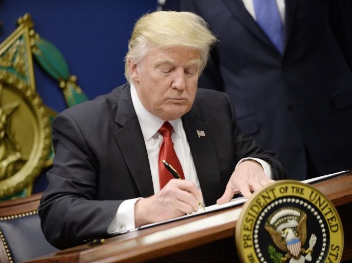 US President Donald J. Trump signs Executive Orders in the Hall of Heroes at the Pentagon in Arlington, Virginia, USA, 27 January 2017.