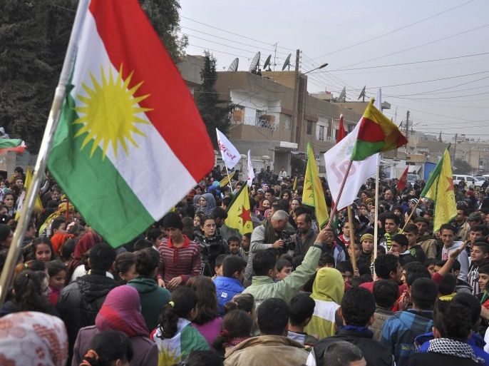 Kurdish civilians gather in the Syrian Kurdish city of Qamishli as they wave Kurdish flags in celebration after it was reported that Kurdish forces took control of the Syrian town of Kobani January 27, 2015. Kurdish forces battled Islamic State fighters outside Kobani on Tuesday, a monitoring group said, a day after Kurds said they had taken full control of the northern Syrian town following a four-month battle. REUTERS/Delil Souleiman (SYRIA - Tags: POLITICS CIVIL UNREST CONFLICT)