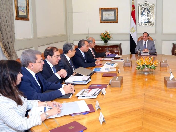 Egyptian President Abdel Fattah al-Sisi (C) attends a meeting with Egypt's Prime Minister Sherif Ismail and members of the government's Economic Ministerial Committee to discuss future economic indicators and figures of the general budget and the results of the talks with the International Monetary Fund (IMF) at the Ittihadiya presidential palace in Cairo, Egypt July 27, 2016 in this handout picture courtesy of the Egyptian Presidency. The Egyptian Presidency/Handout