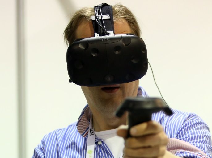 BERLIN, GERMANY - APRIL 26: A visitor uses a virtual reality headset and touch controllers to play a shooting game at the Making Games conference during International Games Week on April 26, 2017 in Berlin, Germany. The event is intended to showcase independant video game design in a city known for its technology and Internet-related startups. (Photo by Adam Berry/Getty Images)