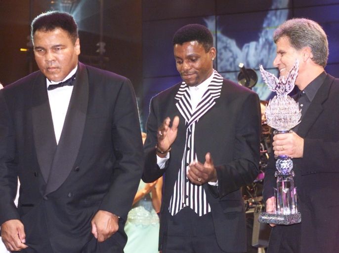 Former Olympic gold medallists Muhammad Ali, Carl Lewis and Mark Spitz leave the stage at the World Sports Awards in Vienna, Austria, November 19, 1999. REUTERS/Files