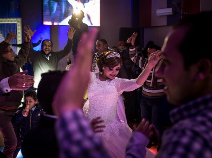 CAIRO, EGYPT - DECEMBER 18: A bride dances during a traditional Egyptian wedding party on December 18, 2016 in Cairo, Egypt. Since the 2011 Arab Spring, Egyptians have been facing a crisis, the uprising brought numerous political changes, but also economic turmoil, increased terror attacks and the unravelling of the once strong tourism sector. In recent weeks Egypt has again been hit by multiple bomb blasts, the most recent killed 26 Christians inside the St Peter and St Paul Church during Sunday mass. As Christians took to the streets chanting anti-government slogans, fears grow of an escalation in militant activity which would further deal damage to a country trying to rebuild. In recent months protests against rising fuel and food prices, calls for mass anti-government demonstrations and the continued terror attacks have seen Egyptian president Abdel Fattah Al-Sisi, suffer a significant drop in popularity. Mr. Al-Sisi has promised change, fearing anger and desperation could lead to popular unrest, however inflation currently sits at the highest level in seven years, jobless rates are above 13percent and more than 90million people are said to be living in poverty. The outlook forced the government to seek a $12 billion bailout from the International Monetary Fund, pushing the country to float the Egyptian pound to qualify for the loan. The move led to a sharp devaluation of the Egyptian pound which now sits at 18EGP to the dollar. The turmoil is affecting not only the poor but both the middle-class and the wealthy as food and commodity prices skyrocket. (Photo by Chris McGrath/Getty Images)