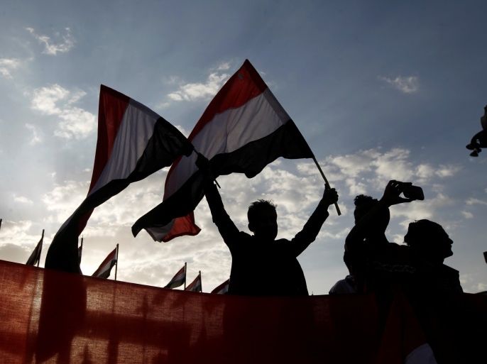 A man waves Yemeni flags during a ceremony marking the anniversary of the September 1962 revolution in Sanaa, Yemen, September 26, 2016. REUTERS/Mohamed al-Sayaghi