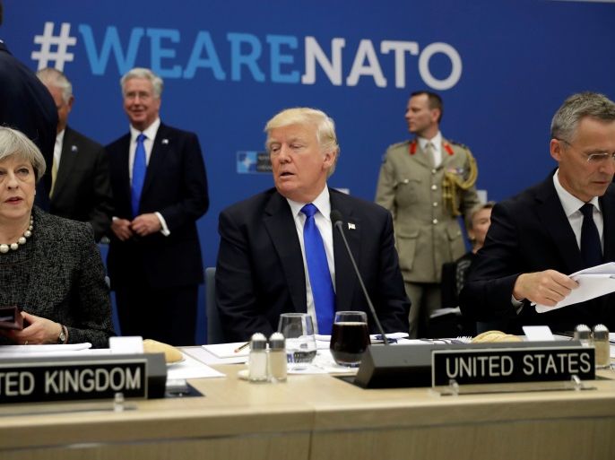 U.S. President Donald Trump (C) is flanked by British Prime Minister Theresa May (L) and NATO Secretary General Jens Stoltenberg during in a working dinner meeting at the NATO headquarters during a NATO summit of heads of state and government in Brussels, Belgium, May 25, 2017. REUTERS/Matt Dunham/Pool