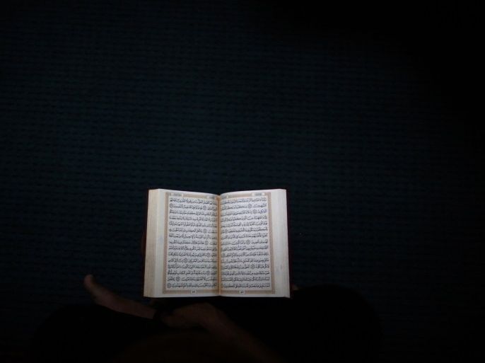 A Nepalese Muslim man reads the Koran during the Muslim holy fasting month of Ramadan at a mosque in Kathmandu July 11, 2014. REUTERS/Navesh Chitrakar (NEPAL - Tags: RELIGION)