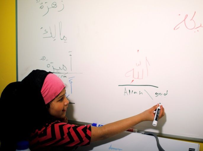 Ten year-old Amira Bey, granddaughter of National Director Malika MacDonald-Rushdan, writes the Arabic and English words for