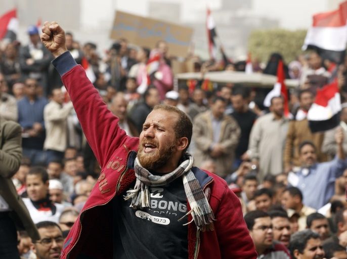 A man holds up his fist during a pro-democracy rally at Tahrir Square, in Cairo February 25, 2011. Egypt's new military rulers, promising to guard against