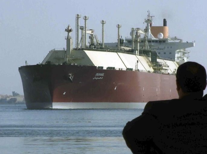 A man looks as the world's biggest Liquefied Natural Gas (LNG) tanker DUHAIL as she crosses through the Suez Canal April 1, 2008. The Qatari tanker, which was built to transfer LNG from Qatar to Europe and the U.S., is on her first trip ever from Qatar to Spain. REUTERS/Stringer (EGYPT)