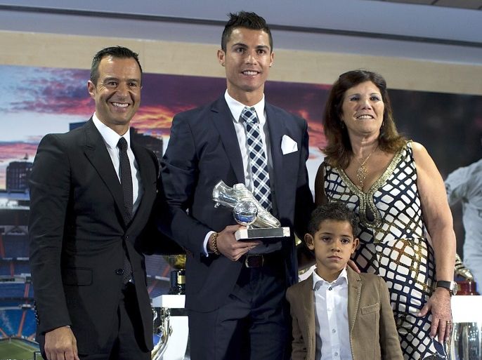 MADRID, SPAIN - OCTOBER 02: Cristiano Ronaldo (2ndL) poses for a picture with his trophy as all-time top scorer of of Real Madrid CF with his son Cristiano Ronald JR, mother Maria Dolores dos Santos and his manager Jorge Mendes (L) at Honour box-seat of Santiago Bernabeu Stadium on October 2, 2015 in Madrid, Spain. Portuguese palyer Cristiano Ronaldo overtook on his last UEFA Champions League match against Malmo FF Raul's record as Real Madrid all-time top scorer. (Photo by Gonzalo Arroyo Moreno/Getty Images)