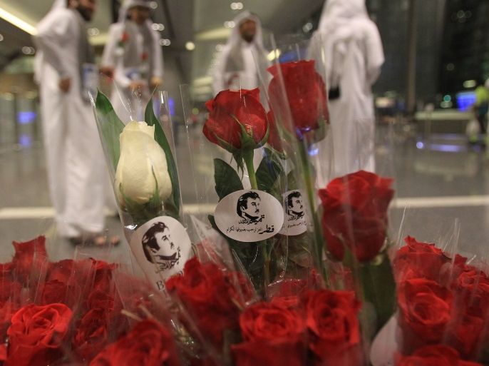 Flowers and pictures of Qatar Emir Sheikh Tamim Bin Hamad Al-Thani are pictured during the arrival of Kuwaiti and Omani citizen at Hamad international airport in Doha, Qatar June 22, 2017. REUTERS/Naseem Zeitoon