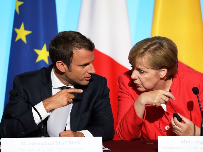 French President Emmanuel Macron (L) and German Chancellor Angela Merkel attend a meeting with EU and African leaders to discuss how to ease the European Union's migrant crisis, at the Elysee Palace in Paris, on August 28, 2017.Seven African and European leaders met in Paris on August 28 to try to build a 'new relationship' aimed at stemming the flow of migrants into Europe from northern Africa in return for aid. / AFP PHOTO / ludovic MARIN (Photo credit shoul
