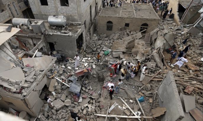 Yemenis stand on the rubble of houses destroyed in a suspected Saudi-led coalition air strike in Sanaa on June 9, 2017.Four civilians, including two teenagers, died 'in a strike by the coalition that targeted a civilian house behind the presidential palace in the south of the capital', a medical source said. / AFP PHOTO (Photo credit should read /AFP/Getty Images)