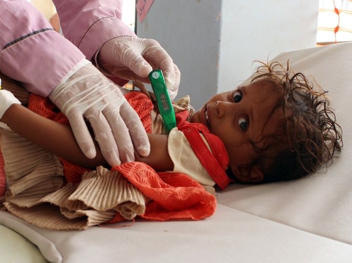 TOPSHOT - A Yemeni child suspected of being infected with cholera is checked by a doctor at a makeshift hospital operated by Doctors Without Borders (MSF) in the northern district of Abs in Yemen's Hajjah province , on July 16, 2017.The country has also been hit by a cholera outbreak that has killed more than 1,600 people and left some 270,000 infected. / AFP PHOTO / STRINGER (Photo credit should read STRINGER/AFP/Getty Images)