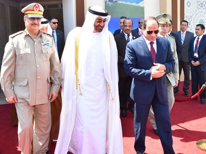 Egyptian President Abdel Fattah al-Sisi (R) arrives with Arab leaders Sheikh Mohammed bin Zayed (C), Crown Prince of Abu Dhabi, and General Khalifa Haftar (L), commander in the Libyan National Army and members of the Egyptian military at the opening of the Mohamed Najib military base, the graduation of new graduates from military colleges, and the celebration of the 65th anniversary of the July 23 revolution at El Hammam City in the North Coast, in Marsa Matrouh, Egypt,