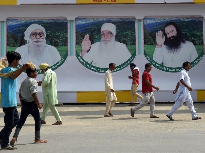 Followers of the controversial Indian guru Ram Rahim Singh are seen outside the 'Dera Sacha Sauda' ashram in Sirsa on August 27, 2017.Supporters of an Indian guru ended a tense standoff with soldiers on August 27 after the 'godman' was convicted of rape, but authorities are bracing for more trouble on the eve of his sentencing after rioting by devotees left 36 dead. Thousands of followers of Ram Rahim Singh had congregated in the spiritual headquarters of his sect in the northern state of Haryana over the weekend and refused to leave, despite calls from police and troops for them to disperse. / AFP PHOTO / Money SHARMA (Photo credit should read MONEY SHARMA/AFP/Getty Images)