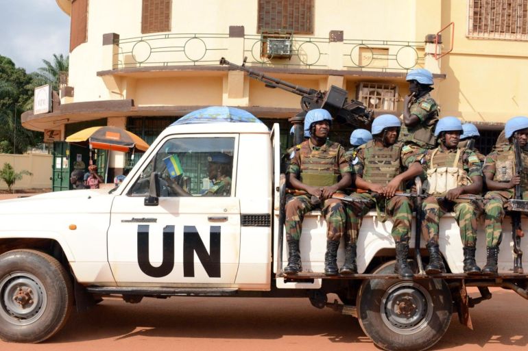 UN peacekeeping soldiers from Rwanda patrol on December 09, 2014 in Bangui. The UN peacekeeping mission currently counts 8,600 people on the ground, and plans to increase this number to 12,000. AFP PHOTO / Pacome PABANDJI