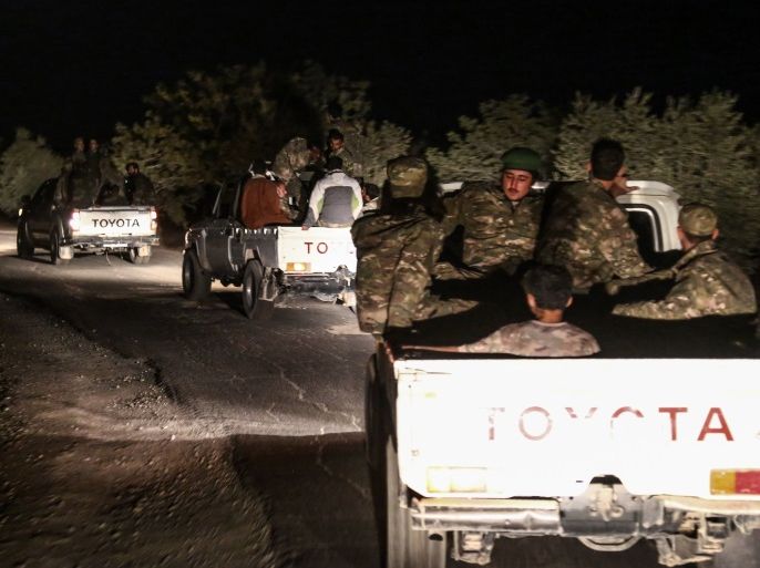 Pro-Ankara Syrian rebel fighters are seen riding on pickup trucks near the village of Hawar Killis along the Syrian-Turkish border in the northern province of Aleppo on October 6, 2017, as they advance towards jihadist-controlled Idlib province.Turkish President Recep Tayyip Erdogan said in a televised speech on October 7 that the pro-Ankara Syrian rebels were 'taking new steps to ensure security in Idlib'.Erdogan later told reporters the operation was led by 'Free Syrian Army' (FSA) rebels and that the Turkish army was not yet operating there. / AFP PHOTO / Nazeer al-Khatib (Photo credit should read NAZEER AL-KHATIB/AFP/Getty Images)