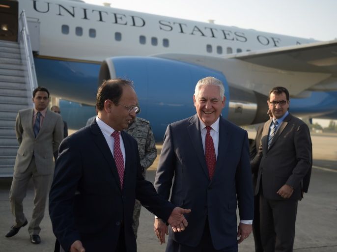 U.S. Secretary of State Rex Tillerson chats with Pakistani foreign office official Sajid Bilal upon his arrival at Pakistan's Nur Khan military airbase in Islamabad, Pakistan October 24, 2017. REUTERS/Aamir Qureshi/Pool
