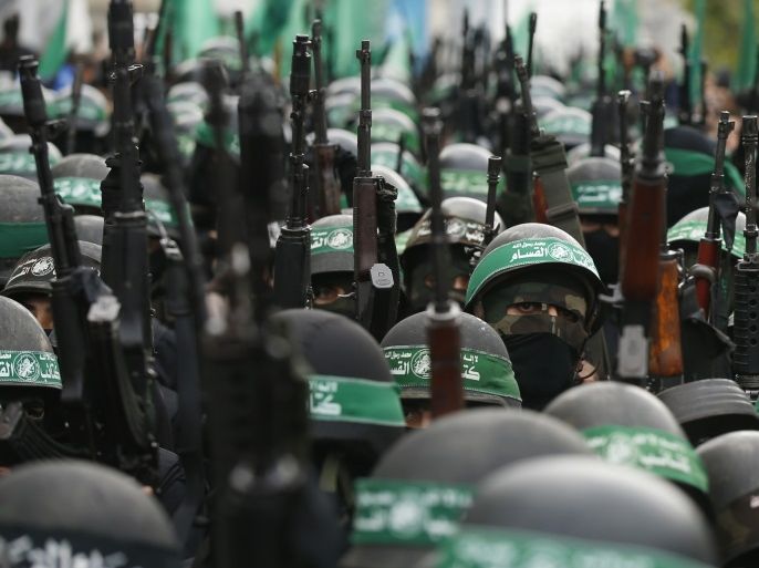 Palestinian members of al-Qassam Brigades, the armed wing of the Hamas movement, take part in a military parade marking the 27th anniversary of Hamas' founding, in Gaza City December 14, 2014. REUTERS/Mohammed Salem (GAZA - Tags: POLITICS MILITARY ANNIVERSARY)