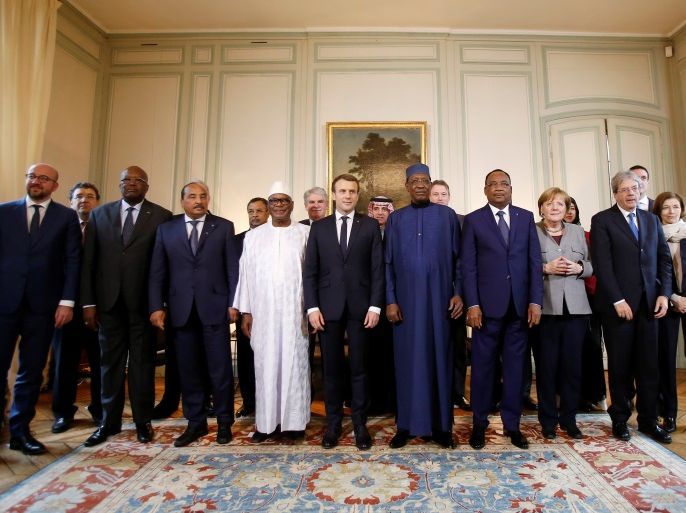 From L, Belgian Prime Minister Charles Michel, President of Burkina Faso Roch Marc Christian Kabore, Mauritania's President Mohamed Ould Abdel Aziz, Mali’s President Ibrahim Boubacar Keita, French President Emmanuel Macron, Chad's President Idriss Deby, Niger's President Mahamadou Issoufou, German Chancellor Angela Merkel and Italy's Prime Minister Paolo Gentiloni pose for a group photo during a conference to discuss how to speed up the implementation of the G5 West African counter-terrorism force, in La Celle Saint-Cloud, near Paris, France, December 13, 2017. REUTERS/Michel Euler/Pool