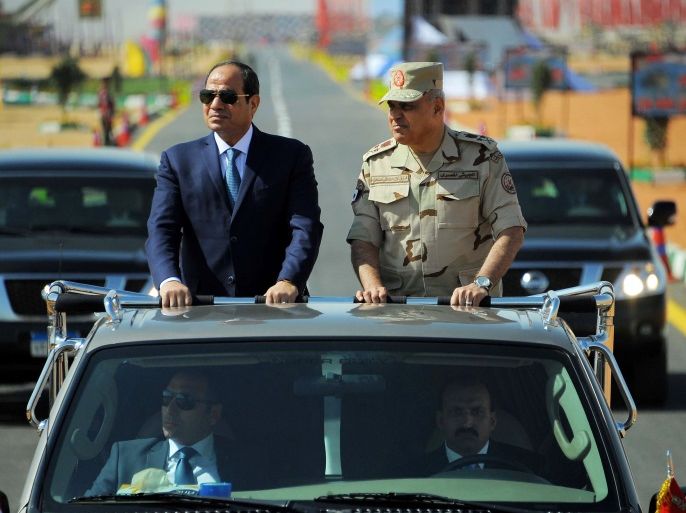 Egyptian President Abdel Fattah al-Sisi (L) rides a vehicle with Egypt's Minister of Defense Sedki Sobhi during a presentation of combat efficiency and equipment of the armed forces in Suez, Egypt, October 29, 2017 in this handout picture courtesy of the Egyptian Presidency. The Egyptian Presidency/Handout via REUTERS ATTENTION EDITORS - THIS IMAGE WAS PROVIDED BY A THIRD PARTY