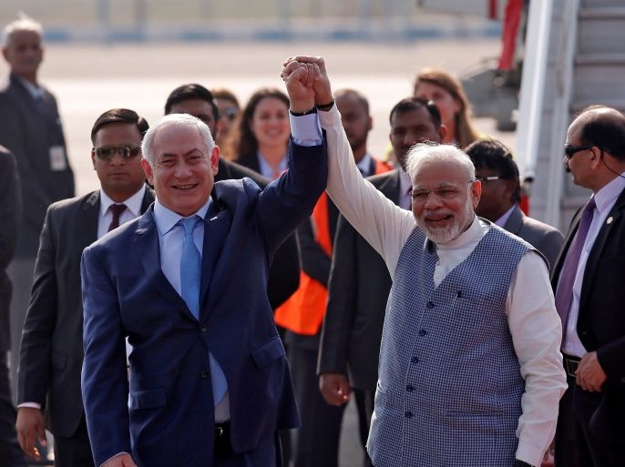 Israeli Prime Minister Benjamin Netanyahu and his Indian counterpart Narendra Modi raise their arms upon Netanyahu’s arrival at Air Force Station Palam in New Delhi, India, January 14, 2018. REUTERS/Adnan Abidi