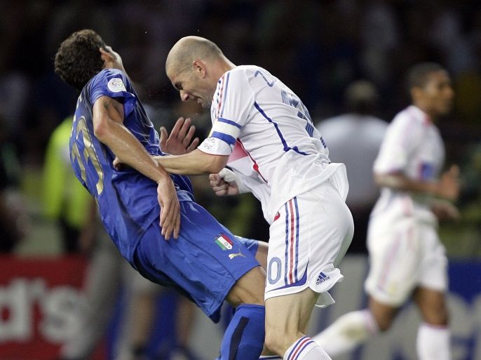 Italy's Marco Materazzi falls on the pitch after being head-butted by France's Zinedine Zidane (R) during their World Cup 2006 final soccer match in Berlin in this July 9, 2006 file photo. France captain Zinedine Zidane was sent off in extra time after headbutting Italy's Marco Materazzi in the Berlin World Cup soccer final with the score tied at 1-1. Materazzi had levelled the score after Zidane scored the opening goal from a penalty. Italy went on to win the penalty shootout 5-3. Picture taken July 9, 2006. To match feature -DECADE/TIMELINE HOLLAND OUT REUTERS/Peter Schols/GPD/Handout (SPORT SOCCER)