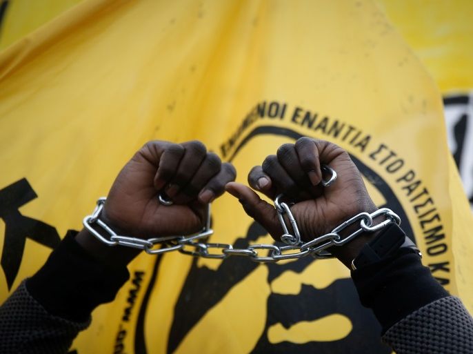 An African migrant living in Greece raises his chained hands during a protest against recent reports of migrant slavery in Libya, in Athens, Greece, December 2, 2017. REUTERS/Costas Baltas