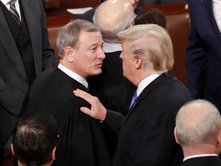 U.S. President Donald Trump (R) talks with U.S. Supreme Court Chief Justice John Roberts as he departs after delivering his State of the Union address to a joint session of the U.S. Congress on Capitol Hill in Washington, U.S. January 30, 2018. REUTERS/Jonathan Ernst