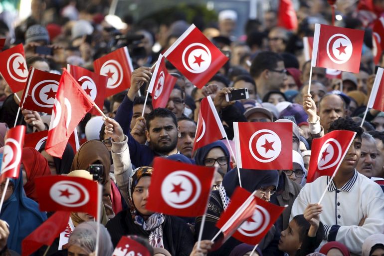 People wave national flags during celebrations marking the fifth anniversary of Tunisia's 2011 revolution, in Habib Bourguiba Avenue in Tunis, Tunisia January 14, 2016. REUTERS/Zoubeir Souissi