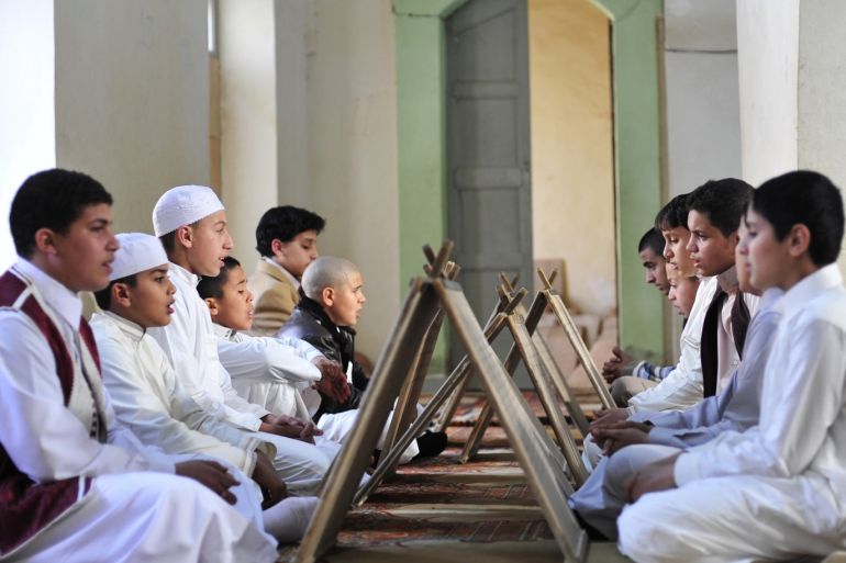 Libyan boys sit in front of wooden slates as they memorize the Koran at a school in Benghazi March 4, 2013. REUTERS/Esam Al-Fetori (LIBYA - Tags: RELIGION SOCIETY TPX IMAGES OF THE DAY)