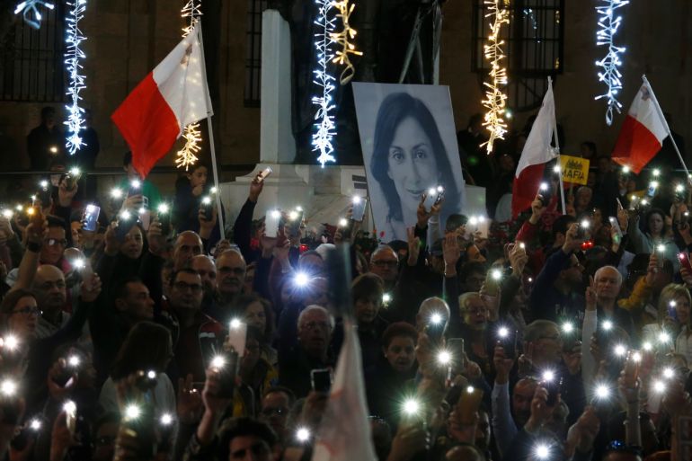 Protesters hold flags of Malta during a demonstration demanding justice over the murder of journalist Daphne Caruana Galizia, outside the Court of Justice, in Valletta Malta, December 1, 2019. REUTERS/Darrin Zammit Lupi