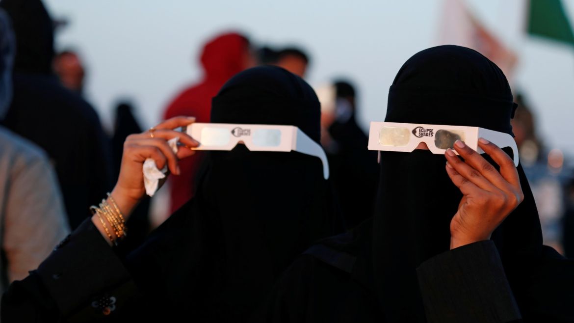 Saudi women wearing special protective glasses monitor the annular solar eclipse on Jabal Arba (Four Mountains) in Hofuf, in the Eastern Province of Saudi Arabia, December 26, 2019. REUTERS/Hamad I Mohammed