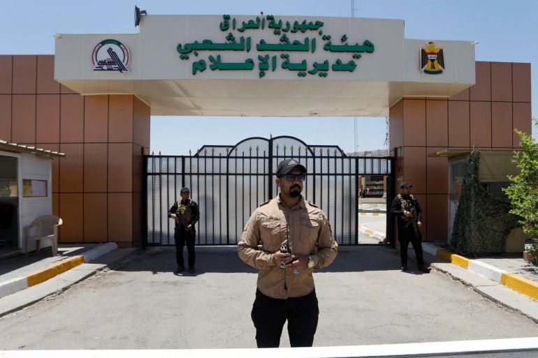 Members of Iraqi Popular Mobilization Forces (PMF) stand guard at Popular Mobilization Forces Media Center in Baghdad, Iraq July 2, 2019. REUTERS/Khalid Al-Mousily