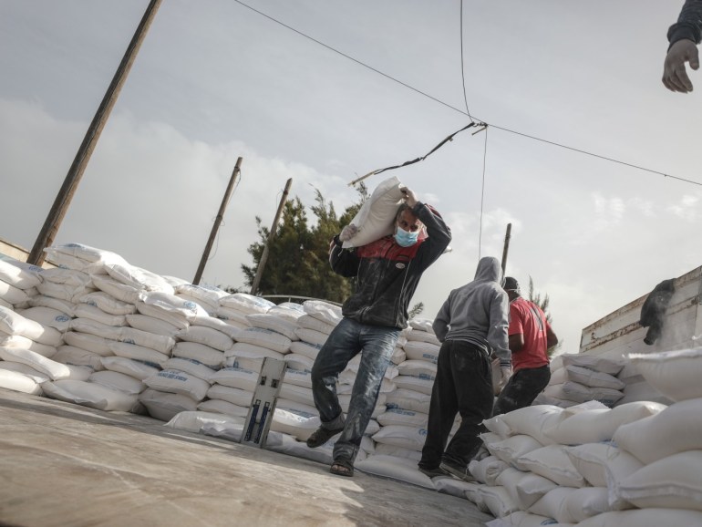 UNRWA distribute food aid to homes in Gaza due to coronavirus- - DEIR AL BALAH, GAZA - MARCH 31: Members of the United Nations Relief and Works Agency (UNRWA) prepare food aids for refugees due to coronavirus (Covid-19) pandemic in Deir Al Balah, Gaza on March 31, 2020. UNRWA launched a new mechanism in the Gaza Strip to ensure that food aid is delivered to refugees' houses.