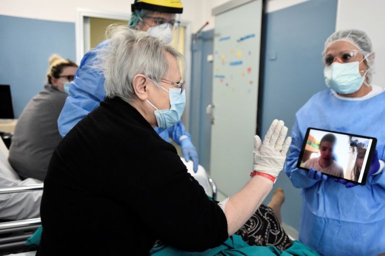 A patient suffering from the coronavirus disease (COVID-19) uses a tablet to speak to a relative who is unable to visit, at the Cernusco sul Naviglio hospital in Milan, Italy, April 7, 2020. REUTERS/Flavio Lo Scalzo