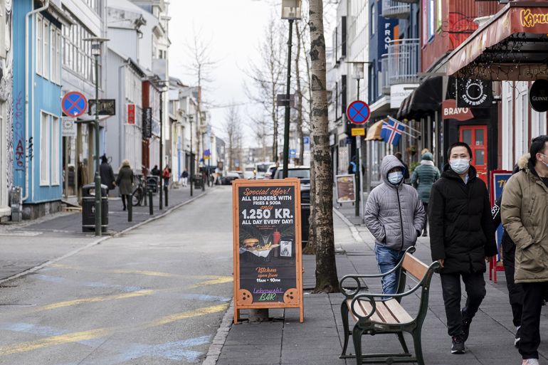 REYKJAVIK, ICELAND - APRIL 3: Tourists with masks walking down Laugavegur street in downtown Reykjavik, April 3, 2020. Ban on gatherings of 20 people or more in Iceland is ongoing during coronavirus (COVID-19) pandemic. ( Ernir Eyjolfsson - Anadolu Agency )