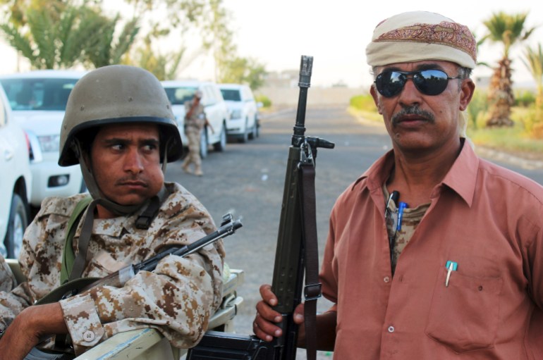 Yemeni soldier chews qat next to a tribal resistance fighter in Marib, Yemen