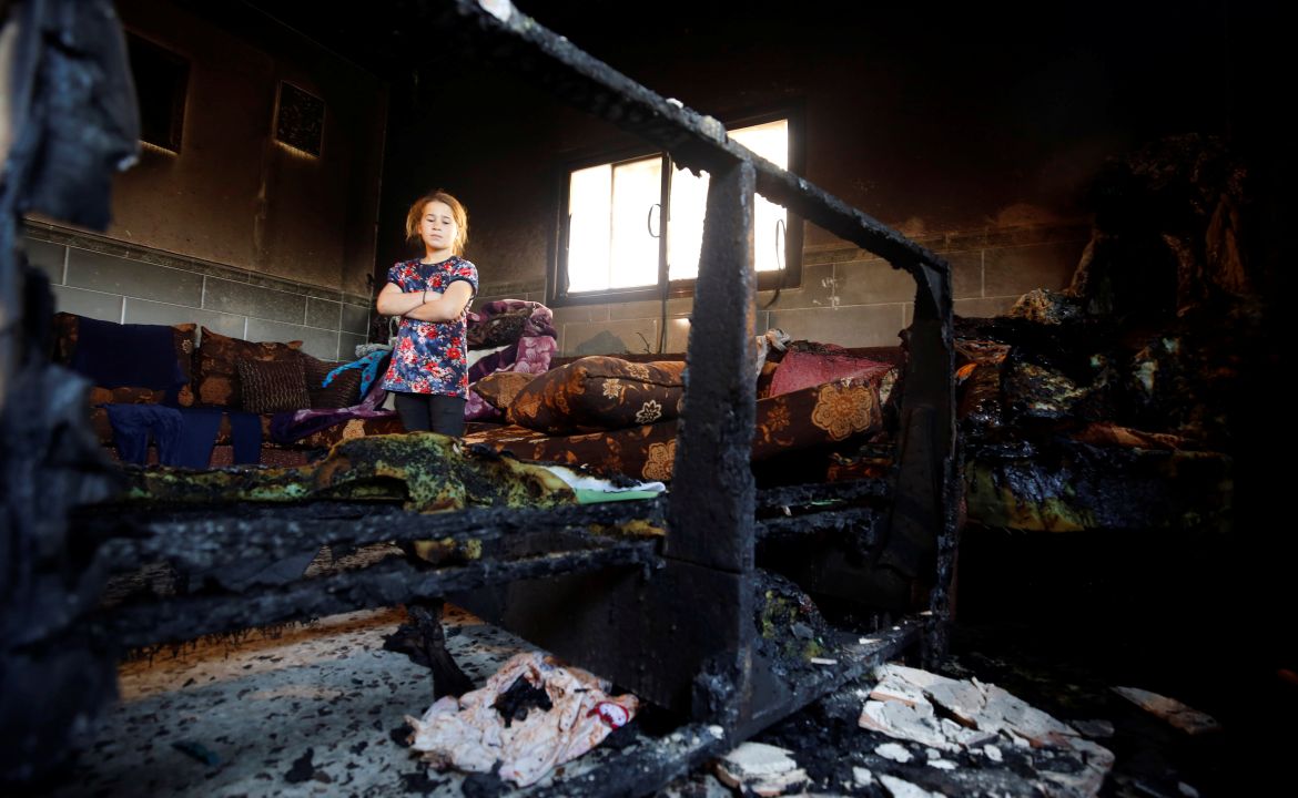 Girl looks at the damage inside the house of Palestinian Dawabsheh family after it was torched in the village of Duma near Nablus, in the occupied West Bank