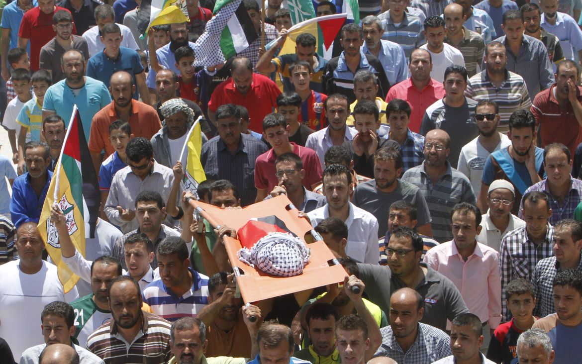 Mourners carry the body of 18-month-old Palestinian baby Ali Dawabsheh, who was killed after his family's house was set on fire in a suspected attack by Jewish extremists in Duma village near Nablus