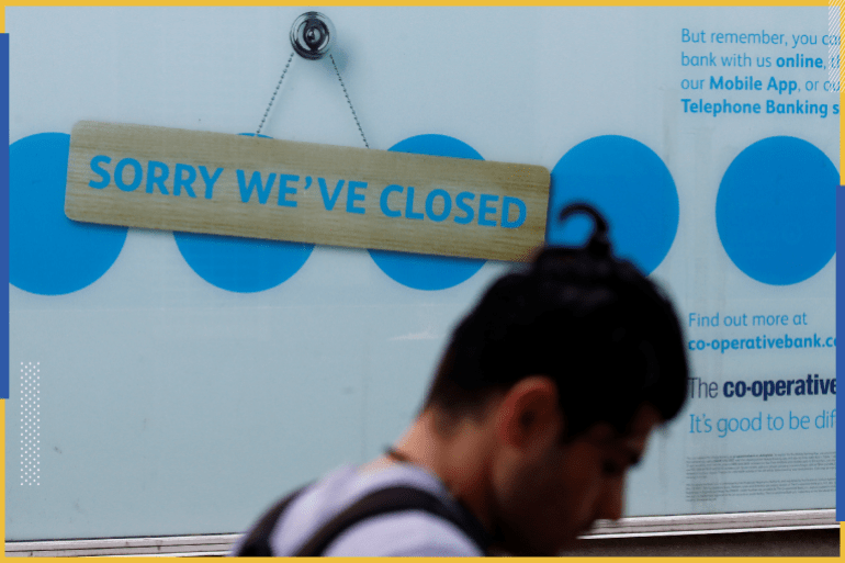 A man walks past a closed branch of the Co-Operative bank following the outbreak of the coronavirus disease (COVID-19) in St Helens, Britain, August 12, 2020. REUTERS/Phil Noble