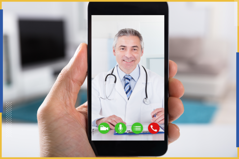Close-up Of A Person Video Conferencing With Happy Male Doctor On Smartphone