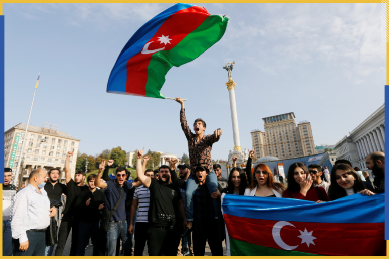 A member of Azerbaijan diaspora shouts slogans and waves Azerbaijan's national flag during a rally in support of his country over the conflict in the Nagorno-Karabakh region, at the Independence Square in Kyiv, Ukraine October 11, 2020. REUTERS/Valentyn Ogirenko