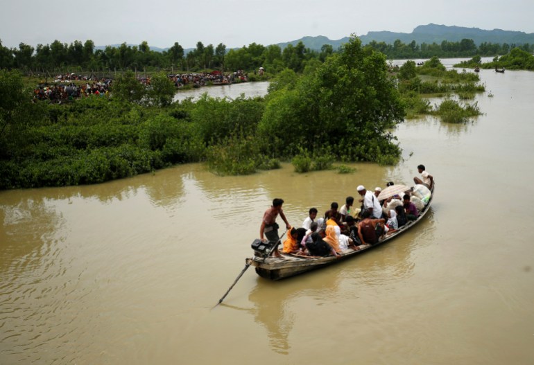 A boat carrying Rohingya refugees is seen leaving Myanmar through Naf river in Maungdaw, Myanmar