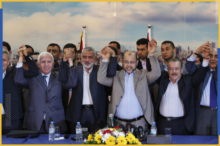 Senior Fatah official Azzam Al-Ahmed (2nd L), head of the Hamas government Ismail Haniyeh (3rd L) and senior Hamas leader Moussa Abu Marzouq (4th L) , hold their hands after announcing a reconciliation agreement in Gaza City April 23, 2014. The Gaza-based Islamist group Hamas and President Mahmoud Abbas's Palestine Liberation Organization (PLO) agreed on Wednesday to implement a unity pact, both sides announced in a joint news conference.REUTERS/Suhaib Salem (GAZA - Tags: MILITARY POLITICS TPX IMAGES OF THE DAY)