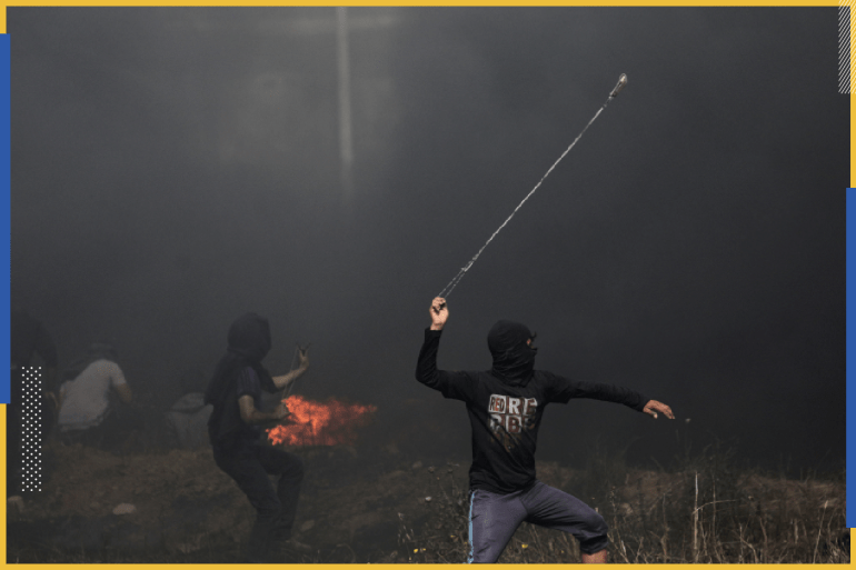 epa06668545 A Palestinian protester throws stones during clashes with Israeli troops near the border with Israel in the east of Gaza City, 13 April 2018 (issued 14 April 2018). According to local sources, more than 700 Palestinians were injured during fresh clashes in the east Gaza Strip near the border with Israel. Thousands of Palestinians in the Gaza strip protested on 13 April as part of the so-called Great March of Return demonstration for the third consecutive week along Gaza's border with Israel, calling for the right of Palestinian refugees and their descendants to return to their homelands. Since the beginning of the Great March of Return on 30 March, riots have been taking place near the Gaza-Israeli border, to which the Israeli army has responded with crowd control and live ammunition. EPA-EFE/MOHAMMED SABER
